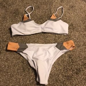 White swimsuit with peach and grey